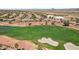 Aerial view of lush golf course with desert landscaping featuring neighborhood at 23225 N Hank Raymond Dr, Sun City West, AZ 85375