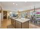 Open concept kitchen with a central island that connects to the living and dining spaces at 23225 N Hank Raymond Dr, Sun City West, AZ 85375