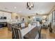 Open-concept kitchen with granite counters flows into the dining area, perfect for entertaining in neutral tones at 23225 N Hank Raymond Dr, Sun City West, AZ 85375