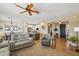 Open-concept living room with tile floors and abundant natural light; perfect for entertaining at 23225 N Hank Raymond Dr, Sun City West, AZ 85375