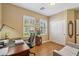 Bright office with hardwood floors, shuttered windows, and closet space offers a versatile area in neutral tones at 23225 N Hank Raymond Dr, Sun City West, AZ 85375