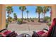 Inviting patio area with comfortable seating and scenic views of lush landscaping and palm trees at 23225 N Hank Raymond Dr, Sun City West, AZ 85375