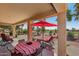 Relaxing covered patio with a table and chairs, perfect for enjoying outdoor meals and the beautiful golf course view at 23225 N Hank Raymond Dr, Sun City West, AZ 85375