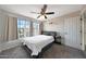 Cozy bedroom with a ceiling fan, three bright windows, and neutral carpet at 2333 E Southern Ave # 1049, Tempe, AZ 85282