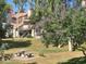 Apartment building with a tile roof, a lawn, picnic table, and flowering tree at 2333 E Southern Ave # 1049, Tempe, AZ 85282