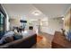 Spacious living room with wood floors, sectional sofa, and views of the fireplace and dining area at 2333 E Southern Ave # 1049, Tempe, AZ 85282