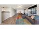 Open-concept living room with wood floors, stylish furnishings, and natural light from a large window at 2333 E Southern Ave # 1049, Tempe, AZ 85282