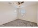 Neutral bedroom with two windows, ceiling fan, and soft carpeting at 2364 N 212Th Ave, Buckeye, AZ 85396