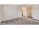 Bedroom with soft carpet, neutral walls, and doorway leading to the bathroom at 2364 N 212Th Ave, Buckeye, AZ 85396