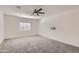 Spacious bedroom featuring neutral carpet, ceiling fan, and a window with blinds at 2364 N 212Th Ave, Buckeye, AZ 85396