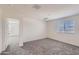 Neutral bedroom with large windows allowing plenty of natural light and plush gray carpeting at 2364 N 212Th Ave, Buckeye, AZ 85396