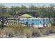 Beautiful community pool with sun umbrellas and plenty of lounge chairs for relaxing at 2364 N 212Th Ave, Buckeye, AZ 85396