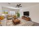 Comfortable living room featuring stylish furnishings, a large TV, and ample natural light at 2364 N 212Th Ave, Buckeye, AZ 85396