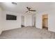Spacious main bedroom featuring a ceiling fan, TV and walk-in closet at 2364 N 212Th Ave, Buckeye, AZ 85396