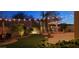 Outdoor space offers a water feature, lush green grass, and ambient string lights for evening enjoyment at 2413 W Kachina Trl, Phoenix, AZ 85041