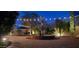 Outdoor water feature with ambient string lights and brick patio create a serene evening setting at 2413 W Kachina Trl, Phoenix, AZ 85041