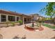 Beautiful backyard with a large fountain, lush landscaping, and brick patio at 2413 W Kachina Trl, Phoenix, AZ 85041