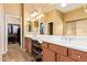 Bathroom featuring double sinks, a large mirror, and walk-in closet for ample storage at 2413 W Kachina Trl, Phoenix, AZ 85041