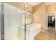 Bathroom featuring a shower and bathtub, with a view of a walk-in closet, creating a functional space at 2413 W Kachina Trl, Phoenix, AZ 85041
