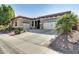 Charming single-story home with a three-car garage, desert landscaping, and a tile roof at 2413 W Kachina Trl, Phoenix, AZ 85041