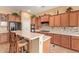 Well-equipped kitchen with modern appliances, spacious countertops, a breakfast bar, and ample cabinet storage at 2413 W Kachina Trl, Phoenix, AZ 85041