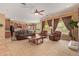 Open-concept living room featuring carpet, armchairs, a sofa, and a view of the kitchen and eating area at 2413 W Kachina Trl, Phoenix, AZ 85041