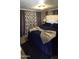 Cozy bedroom with dark blue bedding, carpet and window with privacy curtains at 25 S 102Nd St # 92, Mesa, AZ 85208