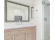 Bright bathroom featuring wood cabinets, marble countertop, glass shower, and decorative mirror at 2636 S Bahama Dr, Gilbert, AZ 85295