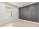 Cozy room with a neutral palette, wood floors, decorative paneled wall, and natural light at 2636 S Bahama Dr, Gilbert, AZ 85295
