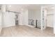 Bright bedroom with light wood floors, a barn door to the bathroom, and stairs to another level at 2636 S Bahama Dr, Gilbert, AZ 85295