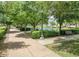 Scenic community walking path with lush trees, manicured bushes, and a serene water feature at 2636 S Bahama Dr, Gilbert, AZ 85295