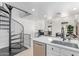 Modern kitchen with stainless steel appliances, white cabinets, and a unique spiral staircase at 2636 S Bahama Dr, Gilbert, AZ 85295