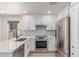 Well-equipped kitchen with stainless steel appliances, quartz countertops, and stylish white cabinetry at 2636 S Bahama Dr, Gilbert, AZ 85295