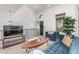Cozy living area featuring modern decor, a comfortable blue sofa, and plenty of natural light at 2636 S Bahama Dr, Gilbert, AZ 85295