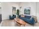Bright living room with plush blue sofa and chair, wood floors, and large windows for ample natural light at 2636 S Bahama Dr, Gilbert, AZ 85295