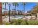 Beautiful community pool surrounded by palm trees, lounge chairs, and well-maintained landscaping at 2636 S Bahama Dr, Gilbert, AZ 85295