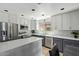 Bright kitchen featuring two-tone cabinets, stainless steel appliances, and an island with a quartz countertop at 2893 W Five Mile Peak Rd, San Tan Valley, AZ 85144