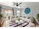 Comfortable living room with a sectional sofa, modern decor, and sliding glass doors leading to the backyard at 2893 W Five Mile Peak Rd, San Tan Valley, AZ 85144