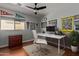 Well-lit home office with modern furniture, a large window, and sports decor at 2893 W Five Mile Peak Rd, San Tan Valley, AZ 85144