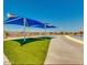 Community pool with shaded seating area and faux grass at 2893 W Five Mile Peak Rd, San Tan Valley, AZ 85144