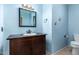 Charming bathroom with a dark wood vanity, custom mirror, classic fixtures, and a toilet at 3010 E Cortez St, Phoenix, AZ 85028