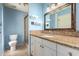 Bathroom featuring a vanity with granite countertop, framed mirror, and walk-in shower at 3010 E Cortez St, Phoenix, AZ 85028
