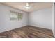 Bright bedroom featuring new floors, a ceiling fan, a window with blinds, and neutral walls at 3010 E Cortez St, Phoenix, AZ 85028