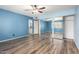 Primary bedroom with wood floors and a door to the primary bathroom at 3010 E Cortez St, Phoenix, AZ 85028