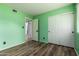 Comfortable bedroom showcasing new floors, a closet with double doors, green walls, and an open doorway at 3010 E Cortez St, Phoenix, AZ 85028