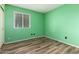 Bedroom with new flooring, a bright window, and green walls creating a refreshing and comfortable space at 3010 E Cortez St, Phoenix, AZ 85028