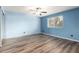 Bright bedroom with light blue walls, laminate flooring, and a ceiling fan at 3010 E Cortez St, Phoenix, AZ 85028