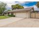 Single story home with a two car garage and an extra parking area at 3010 E Cortez St, Phoenix, AZ 85028