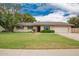 Charming single story home featuring a well-manicured lawn and a two car garage at 3010 E Cortez St, Phoenix, AZ 85028