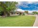 Charming single story home with well-maintained front yard featuring a beautiful flowering shade tree at 3010 E Cortez St, Phoenix, AZ 85028